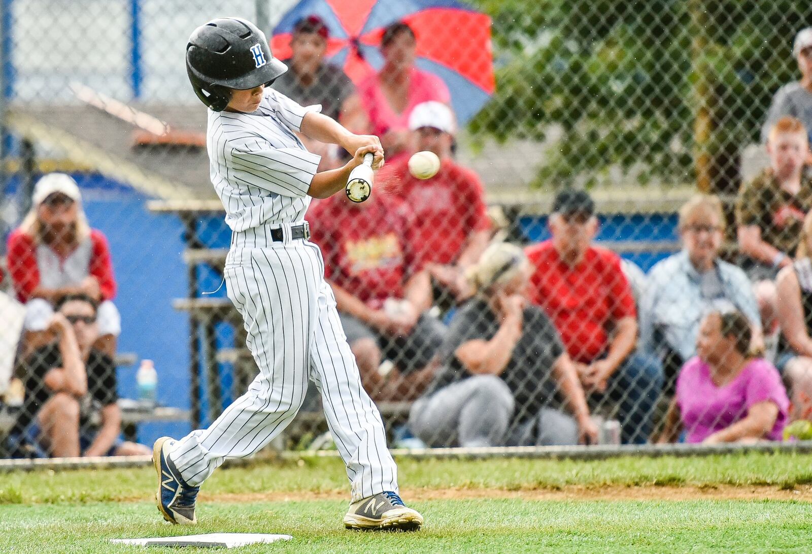 Hamilton West Side’s Clint Moak makes solid contact against Hamilton-Fairfield on Tuesday night in the winners’ bracket final of the District 9 tournament at the West Side complex. NICK GRAHAM/STAFF