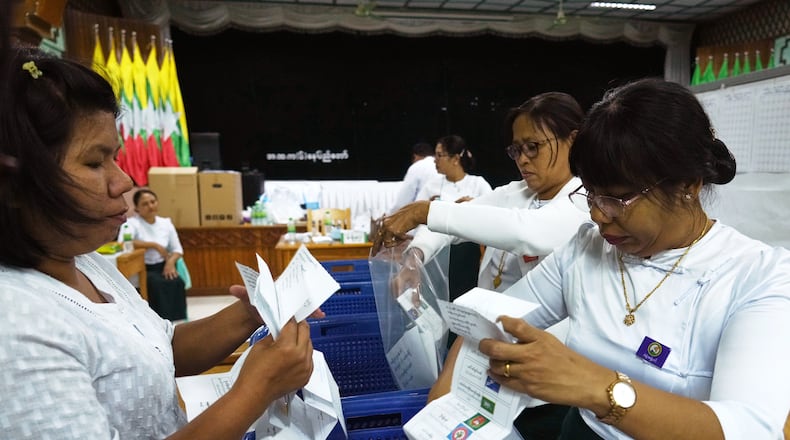 Officials of the Union Election Commission prepare to count votes at a polling station, during the first phase of general election, in Naypyitaw, Myanmar, Sunday, Dec. 28, 2025. (AP Photo/Aung Shine Oo)