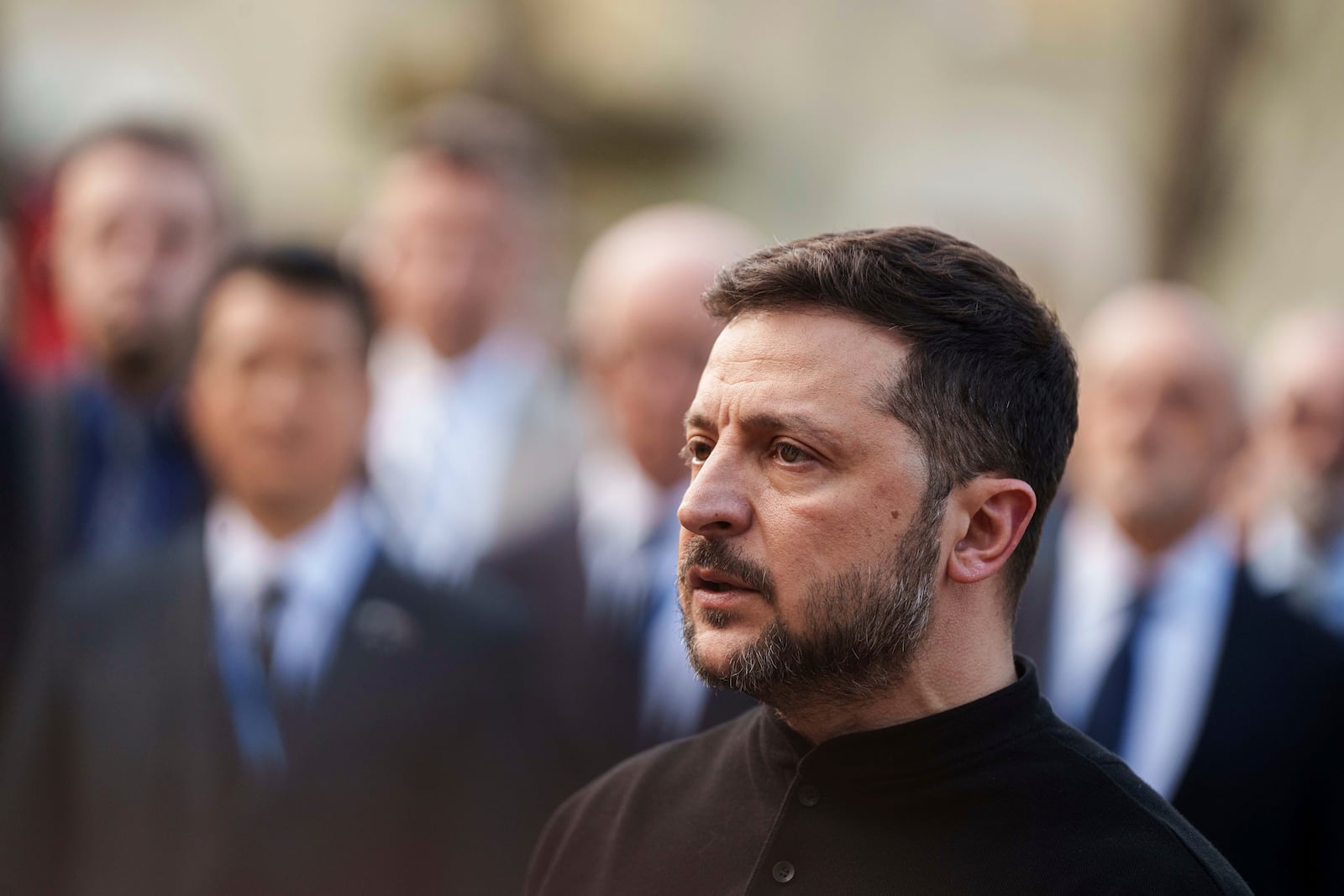 President Volodymyr Zelenskyy answers journalists' questions near a house destroyed by Thursday's Russian strike on a residential neighborhood in Kyiv, Ukraine, on Friday, April 25, 2025. (AP Photo/Evgeniy Maloletka)