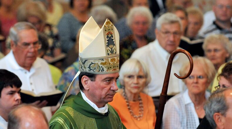 Archbishop Dennis Schnurr walks with the processional at St. Bernard Catholic Church in 2013. Staff photo by Bill Lackey