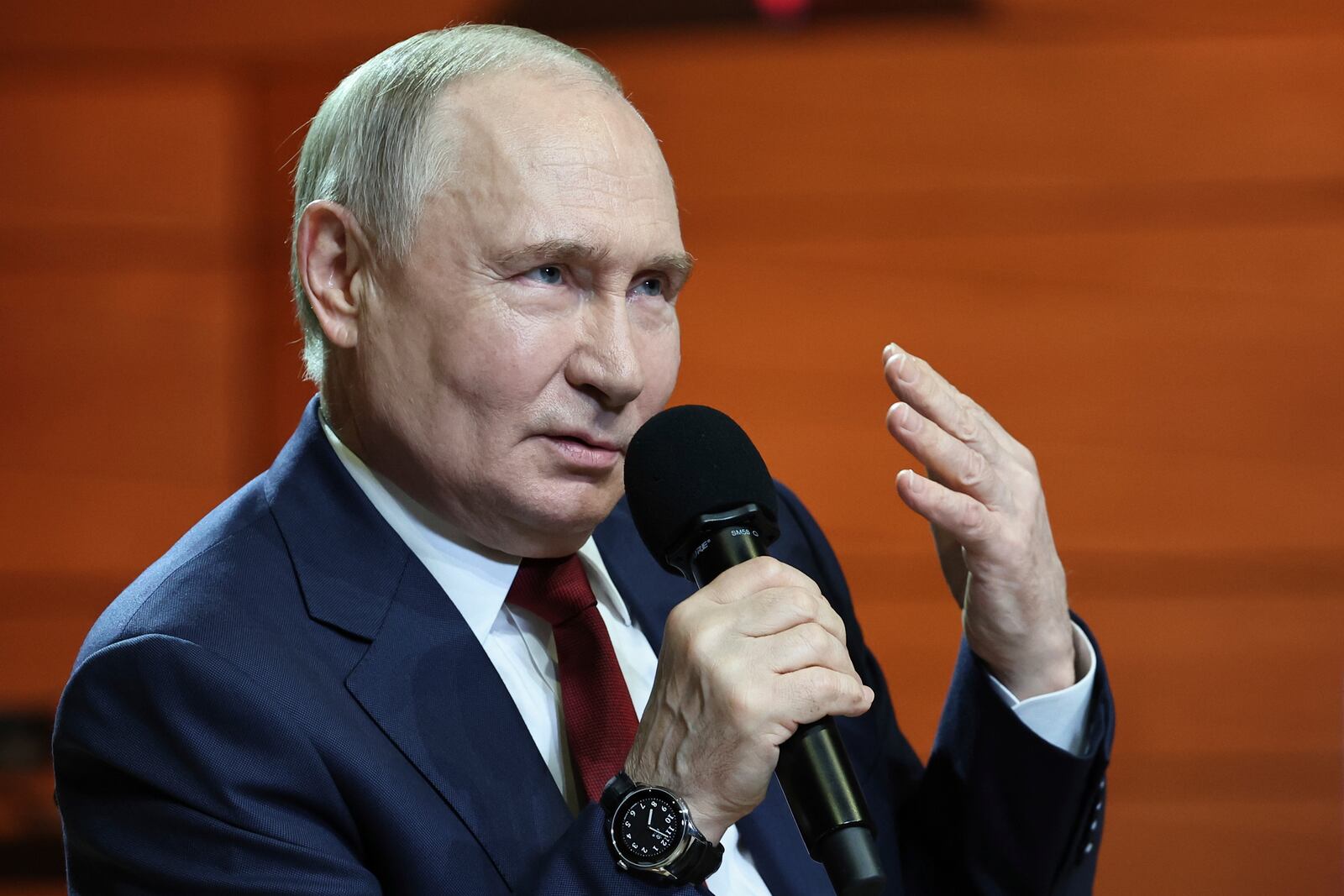 Russian President Vladimir Putin gestures while speaking to students and teachers of the new Secondary Special Music School at the Sirius Park of Science and Art after his phone talk with U.S. President Donald Trump, outside Sochi, Russia, on Monday, May 19, 2025. (Alexander Kazakov, Sputnik, Kremlin Pool Photo via AP)
