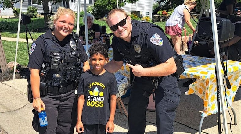 With the help of a lemonade stand and a big inflatable dinosaur, a Fairfield Schools’ 2nd grader recently continued his entrepreneurial, summer tradition of raising thousands of dollars for his school and classmates. Fairfield North Elementary student Cayden Cummings raised more than $2,400 for his school during his one-day but highly advertised opening of his neighborhood lemonade stand. Among his customers were Fairfield Schools' superintendent and Fairfield Twp. police officers (pictured) and firefighters. CONTRIBUTED