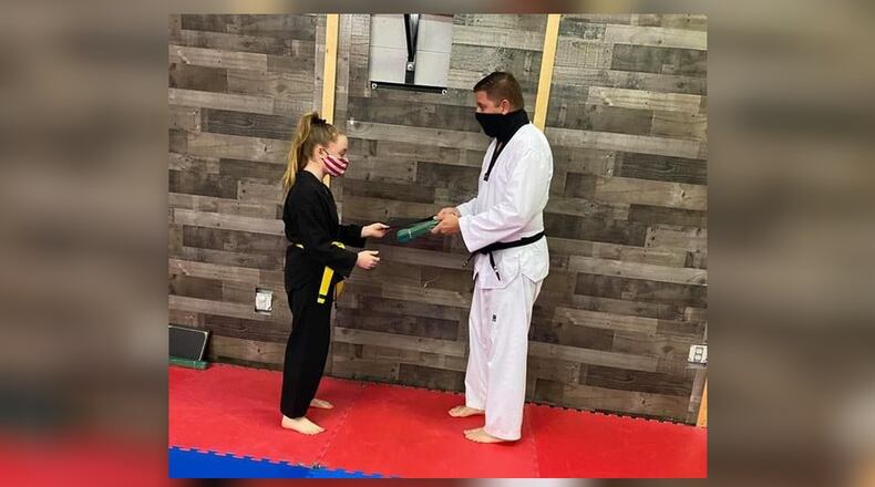 Steven Myers opened Hallasan Summit Martial Arts in Hamilton after the Fitton YMCA, where he taught for five years, cancelled martial arts due to the coronavirus. Here Myers makes a green belt presentation to student Carmen Jenkins after she passed her test. SUBMITTED PHOTO