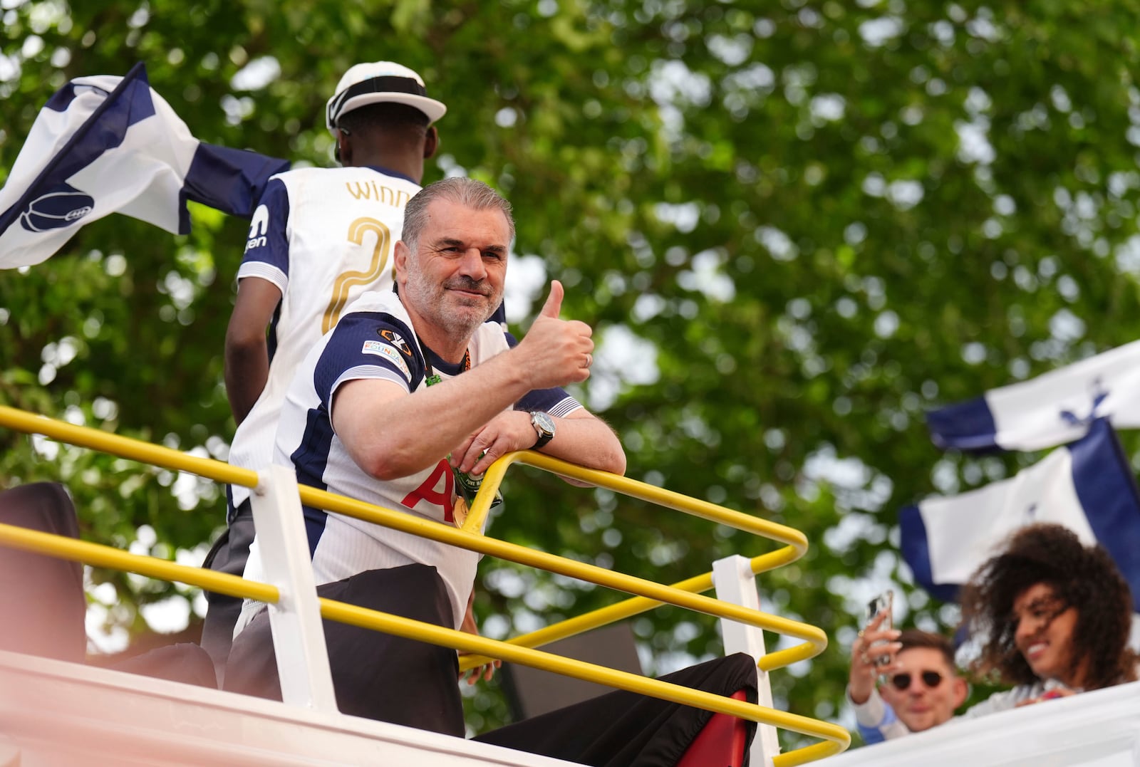 Tottenham Hotspur manager Ange Postecoglou on the open-top team bus during the Europa League winners parade in North London, Friday, May 23, 2025. (John Walton/PA via AP)