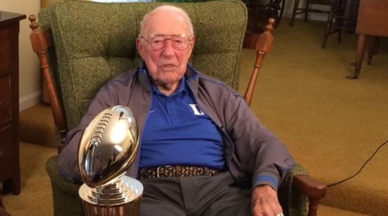Jim Smith, 95, of Hamilton, is the last living football player who played in the 1942 Rose Bowl game when Oregon State upset Duke. Smith is pictured in his Louisville home with the 2017 Rose Bowl trophy.