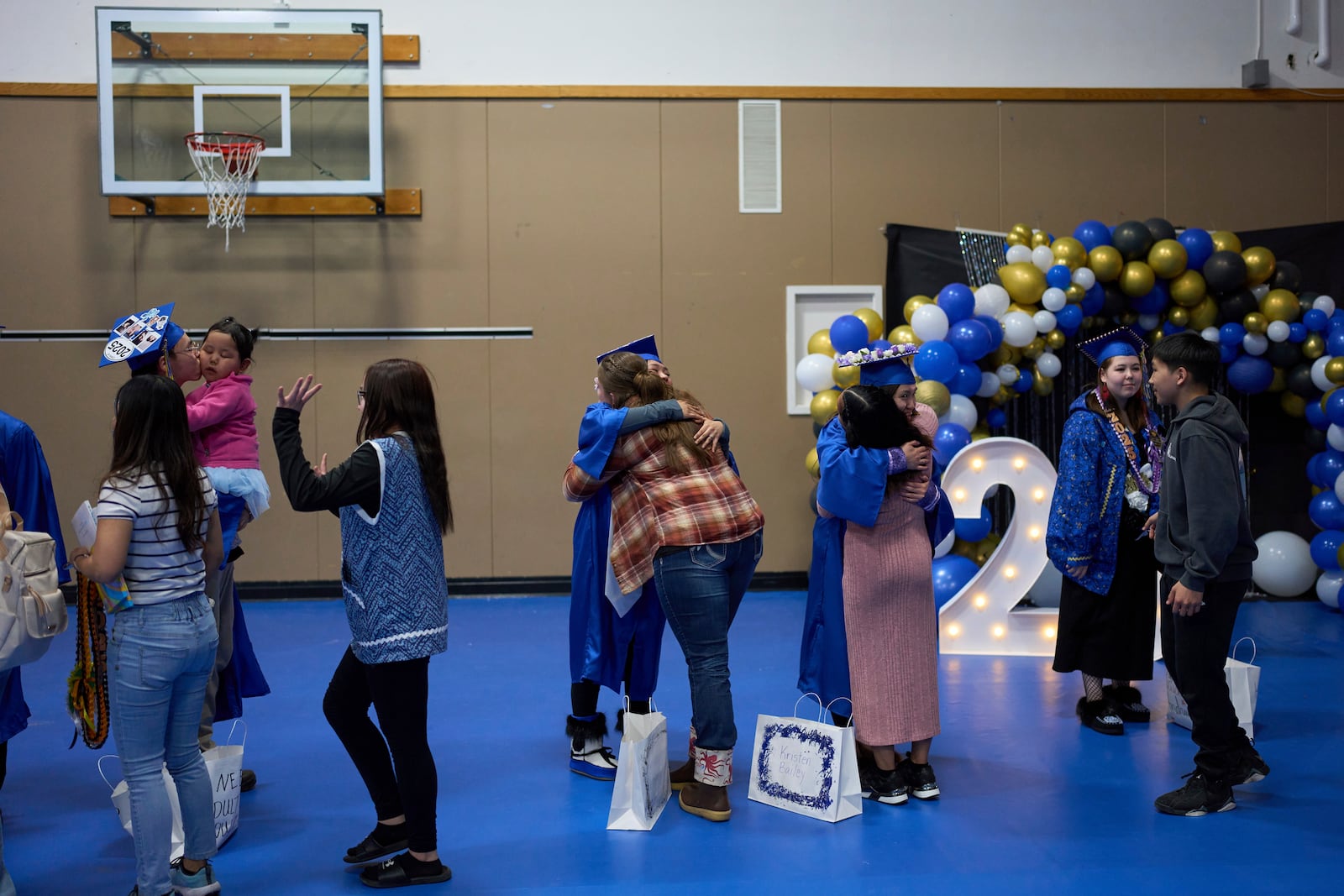 Community and family members congratulate graduating students from the Galena Interior Learning Academy during a ceremony Wednesday, May 21, 2025, in Galena, Alaska. (AP Photo/John Locher)
