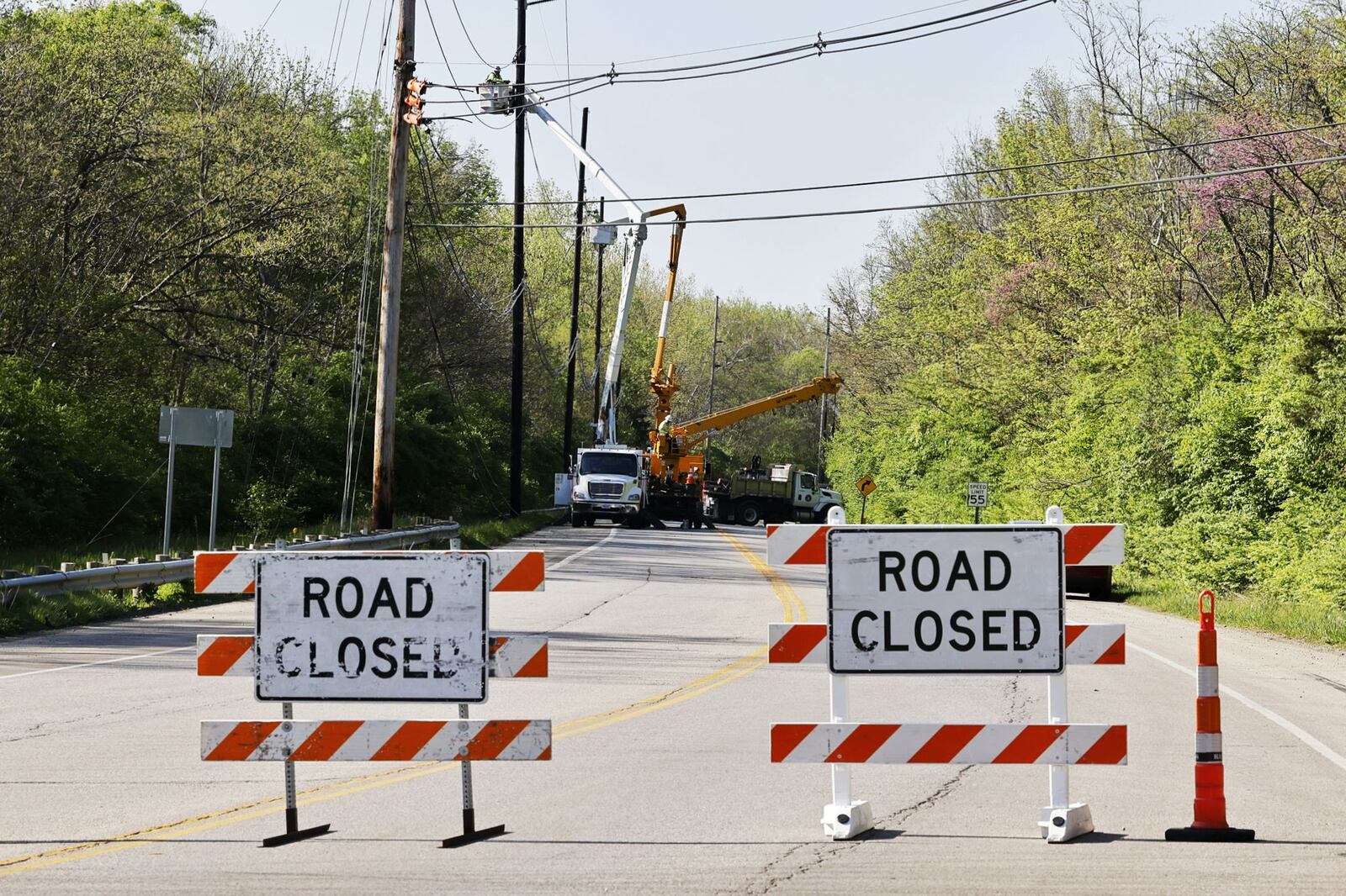 Hamilton-Cleves Road (Ohio 128) is closed today for repairs to utility poles and lines damaged in a crash Saturday night. Nick Graham/STAFF