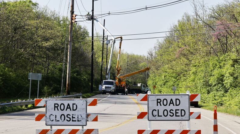 Hamilton-Cleves Road (Ohio 128) is closed today for repairs to utility poles and lines damaged in a crash Saturday night. Nick Graham/STAFF