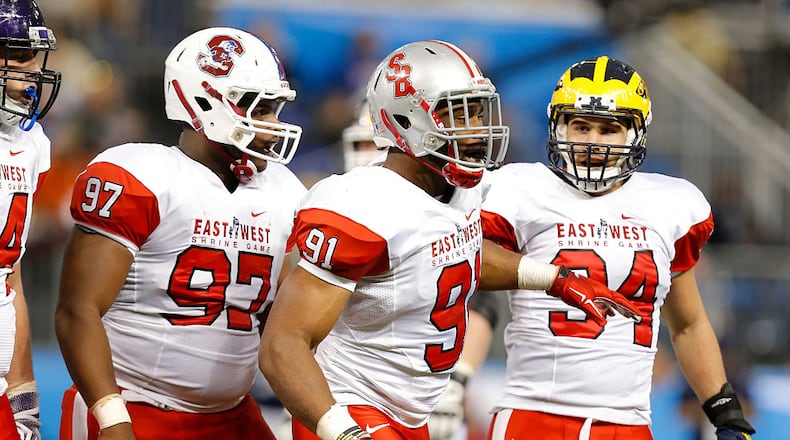 ST. PETERSBURG, FL - JANUARY 23: Javon Hargrave #97 from South Carolina State, Victor Ochi #91 from Stony Brook, and Dean Lowry #94 from Northwestern playing on the East Team react to a tackle during the first half of the East West Shrine Game at Tropicana Field on January 23, 2016 in St. Petersburg, Florida. (Photo by Mike Carlson/Getty Images)