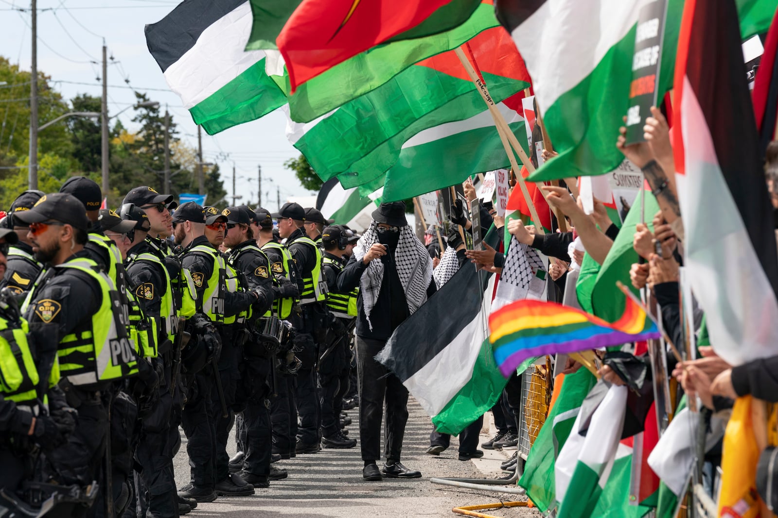 Pro-Palestinian protesters gather along the route of the United Jewish Appeal's annual Walk With Israel march in Toronto, Canada, on Sunday, May 25, 2025. (Arlyn McAdorey/The Canadian Press via AP)