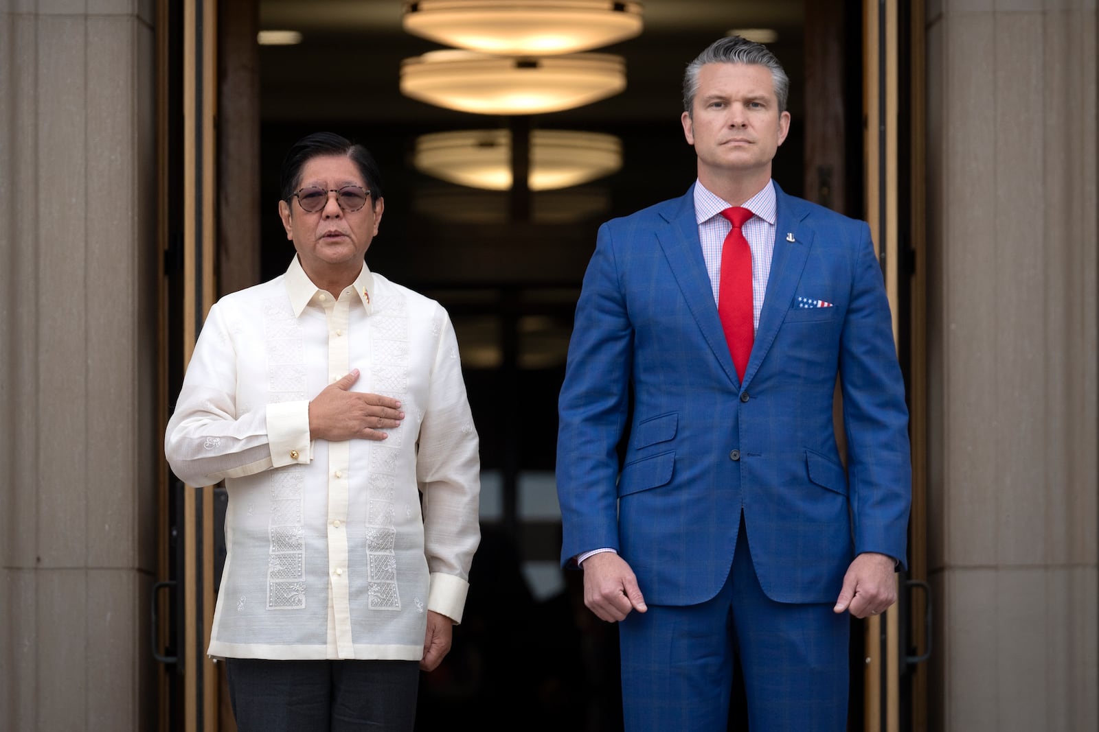 Secretary of Defense Pete Hegseth, right, stands with Philippine President Ferdinand Marcos Jr. during an honor cordon ceremony at the Pentagon, Monday, July 21, 2025, in Washington. (AP Photo/Mark Schiefelbein)