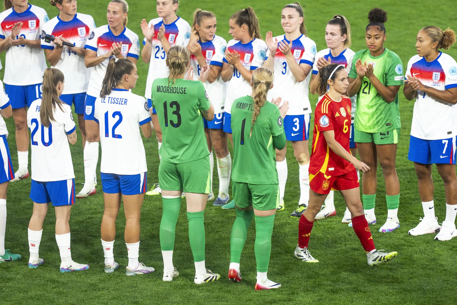 England players applaud Spain's Aitana Bonmati on her way to receive her second place medal at the end of the Women's Euro 2025 final soccer match between England and Spain at St. Jakob-Park in Basel, Switzerland, Sunday, July 27, 2025. (Til Buergy/Keystone via AP)