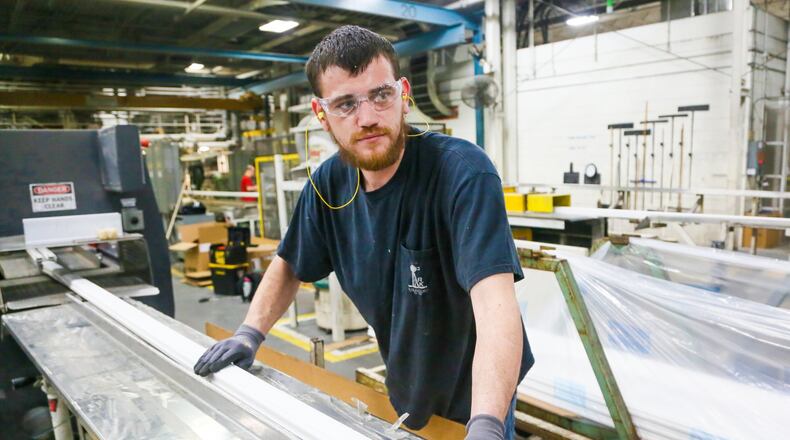 Jake Steffen of Middletown works at an extruder machine at Deceuninck North America in Monroe, Wednesday, April 12, 2017. Deceuninck North America is a fully integrated design, compounding, tooling, and PVC extrusion company that produces energy-efficient vinyl window and door systems. GREG LYNCH / STAFF
