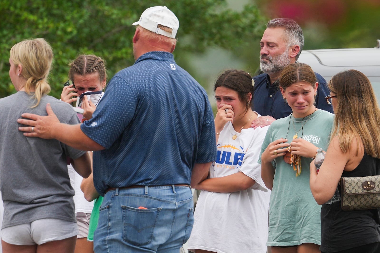 People comfort each other outside the Butt-Holdsworth Memorial Library in Kerville after heavy rainfall caused the Guadalupe River to flood and damage several communities in Central Texas, Saturday, July 5, 2025. (Jason Fochtman/Houston Chronicle via AP)