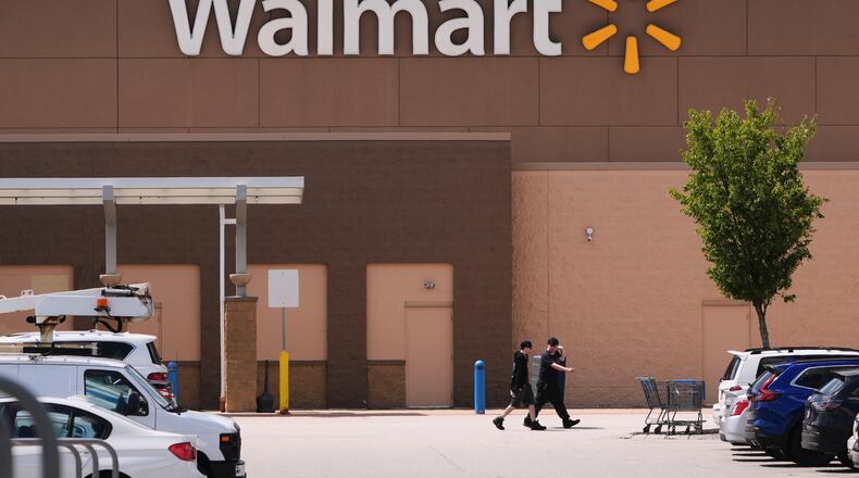FILE - Shoppers walk from the Walmart store, Aug. 14, 2025, in Manchester, N.H. (AP Photo/Charles Krupa, file)