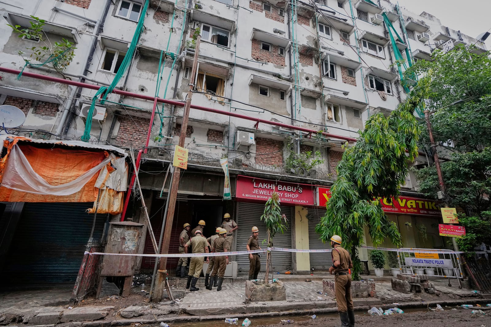 Firefighters inspect a hotel building which caught fire on Tuesday resulting in several deaths, in Kolkata, India, Wednesday, April 30, 2025. (AP Photo/Bikas Das)