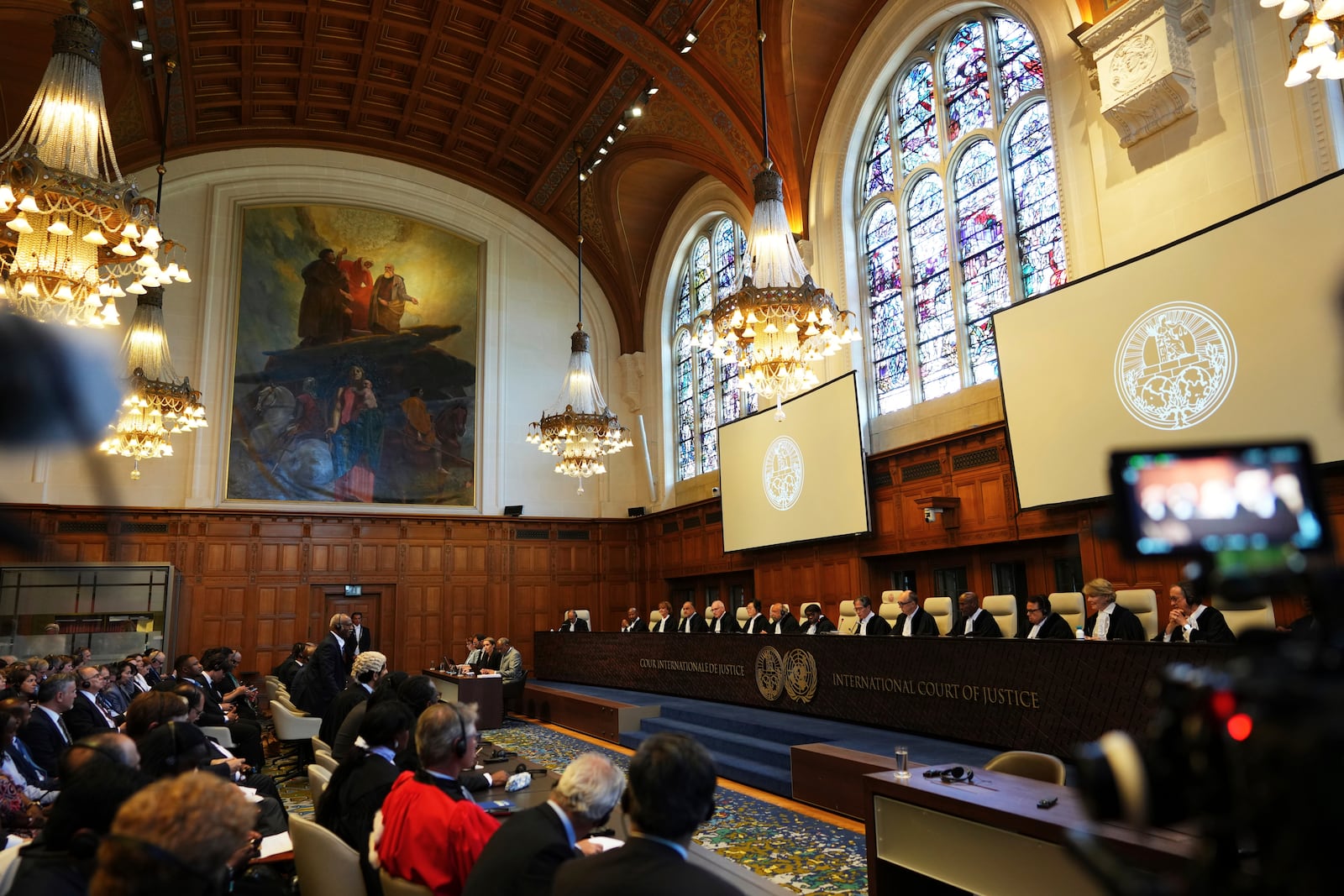 Judges are seated as the International Court of Justice opens a hearing to deliver an advisory opinion on what legal obligations nations have to address climate change and what consequences they may face if they don't, Wednesday, July 23, 2025, in The Hague, Netherlands. (AP Photo/Peter Dejong)