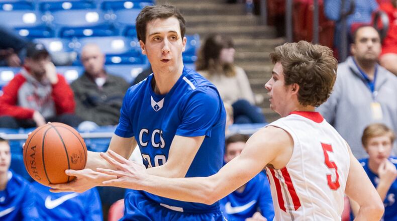 Cincinnati Christian’s Brady Roberts (20) is defended by Trevor King of South Charleston Southeastern during Friday night’s Division IV district final at the University of Dayton Arena. CONTRIBUTED PHOTO BY BRYANT BILLING