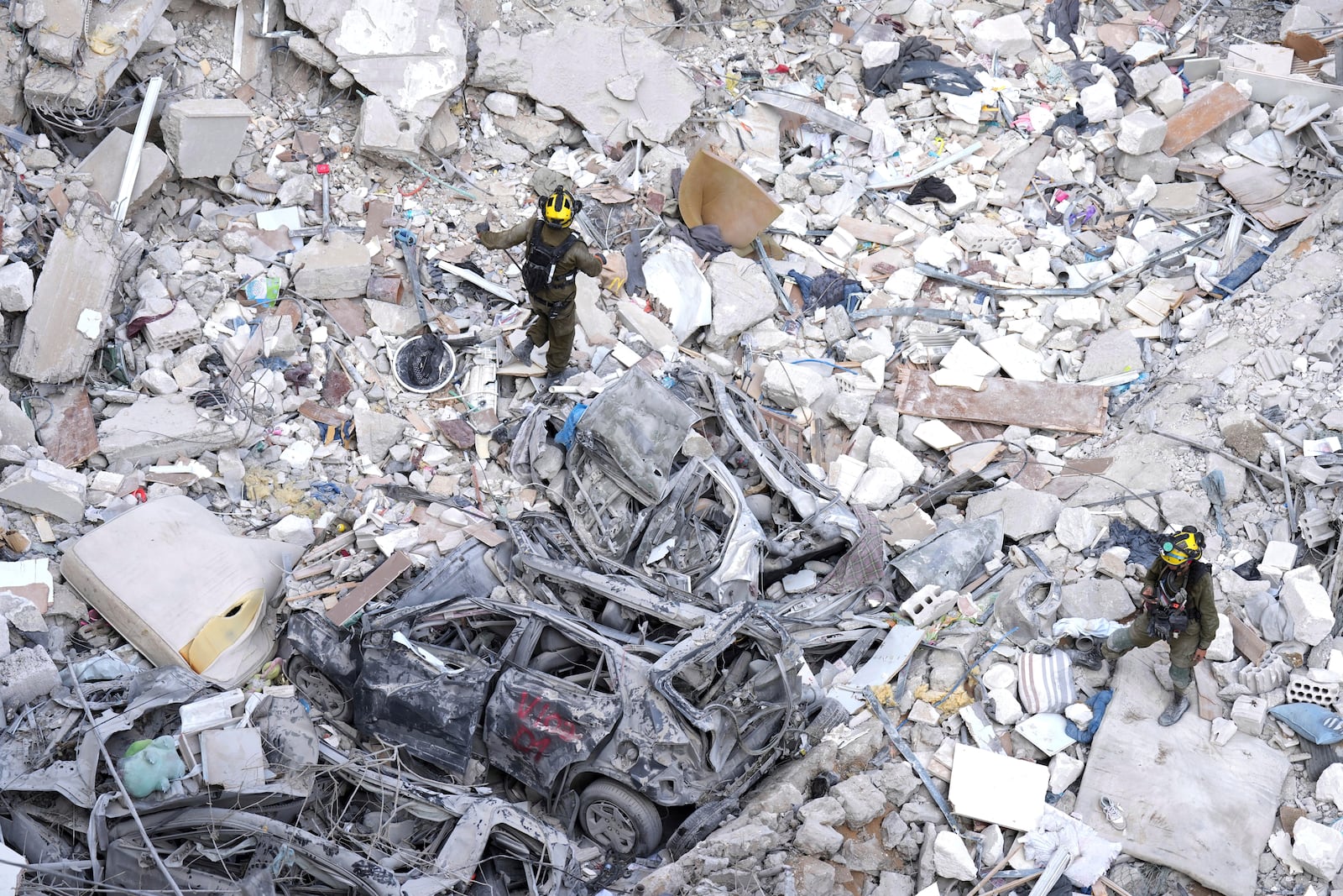 Israeli soldiers search for survivors amid the rubble of residential buildings destroyed by an Iranian missile strike in Bat Yam, central Israel, on Sunday, June 15, 2025. (AP Photo/Ariel Schalit)
