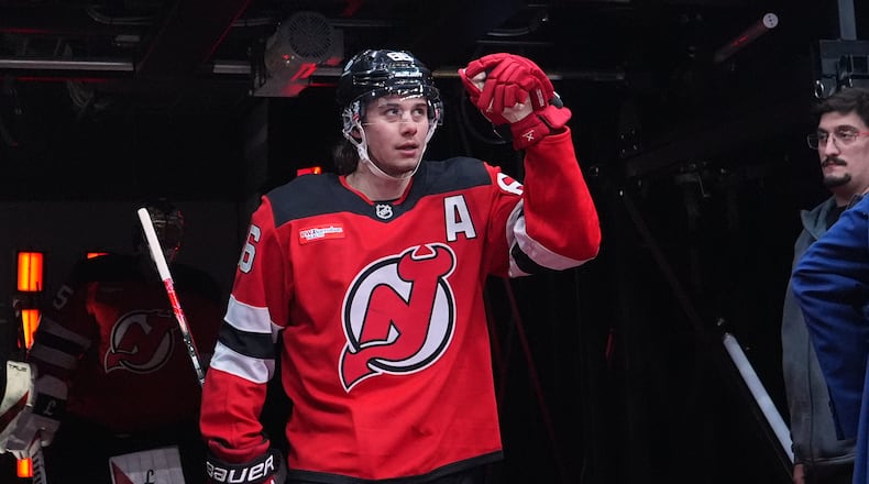 New Jersey Devils' Jack Hughes (86) walks toward the ice to warm up before an NHL hockey game against the Buffalo Sabres Wednesday, Feb. 25, 2026, in Newark, N.J. (AP Photo/Frank Franklin II)