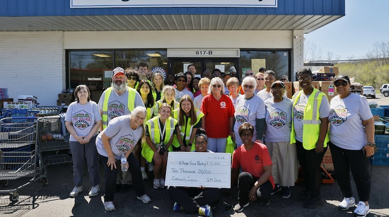The Village Food Pantry was awarded a $10,000 grant from General Motors for the second year in a row for serving hundreds of families at its New Miami site. Village Food Pantry serves hundreds of people with their drive-through Food pantry every Wednesday with the help of numerous volunteers and donors. NICK GRAHAM/STAFF
