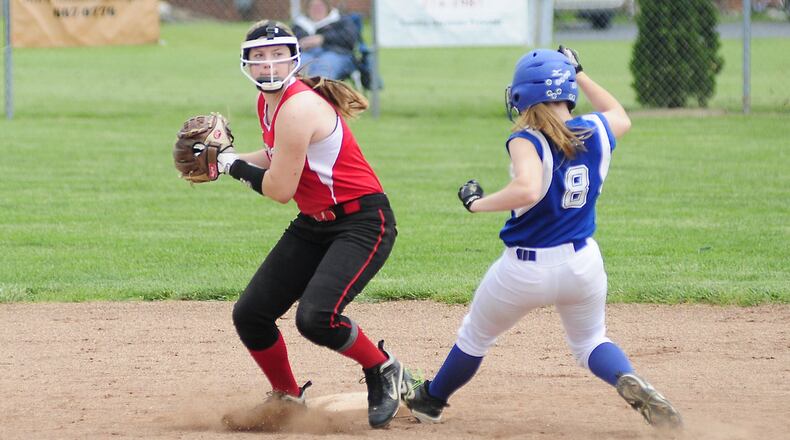 Madison’s Natalie Higgins (5) gets the out on Miami East’s Kris Bigelow (8) and throws to first base during a Division III district final May 25, 2013, at Tippecanoe Middle School. COX MEDIA FILE PHOTO