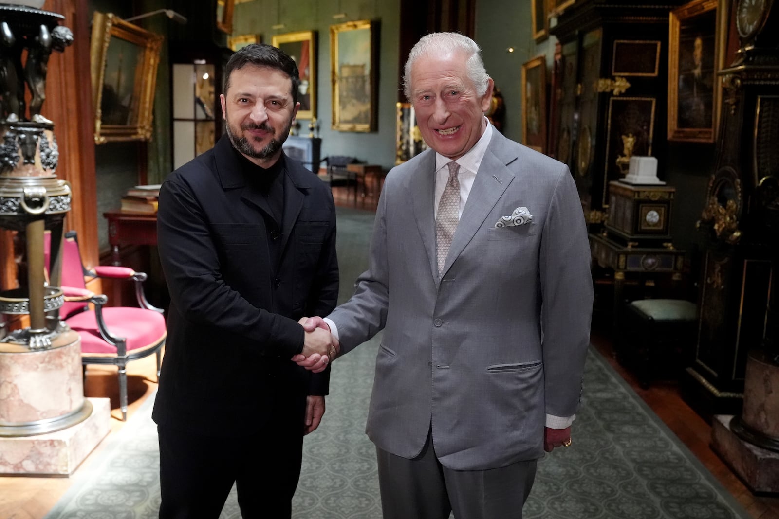 Britain's King Charles III, right, shakes hands with Ukrainian President Volodymyr Zelenskyy on the occasion of their private audience at Windsor Castle, England, Monday, June 23, 2025. (Jonathan Brady/Pool Photo via AP)