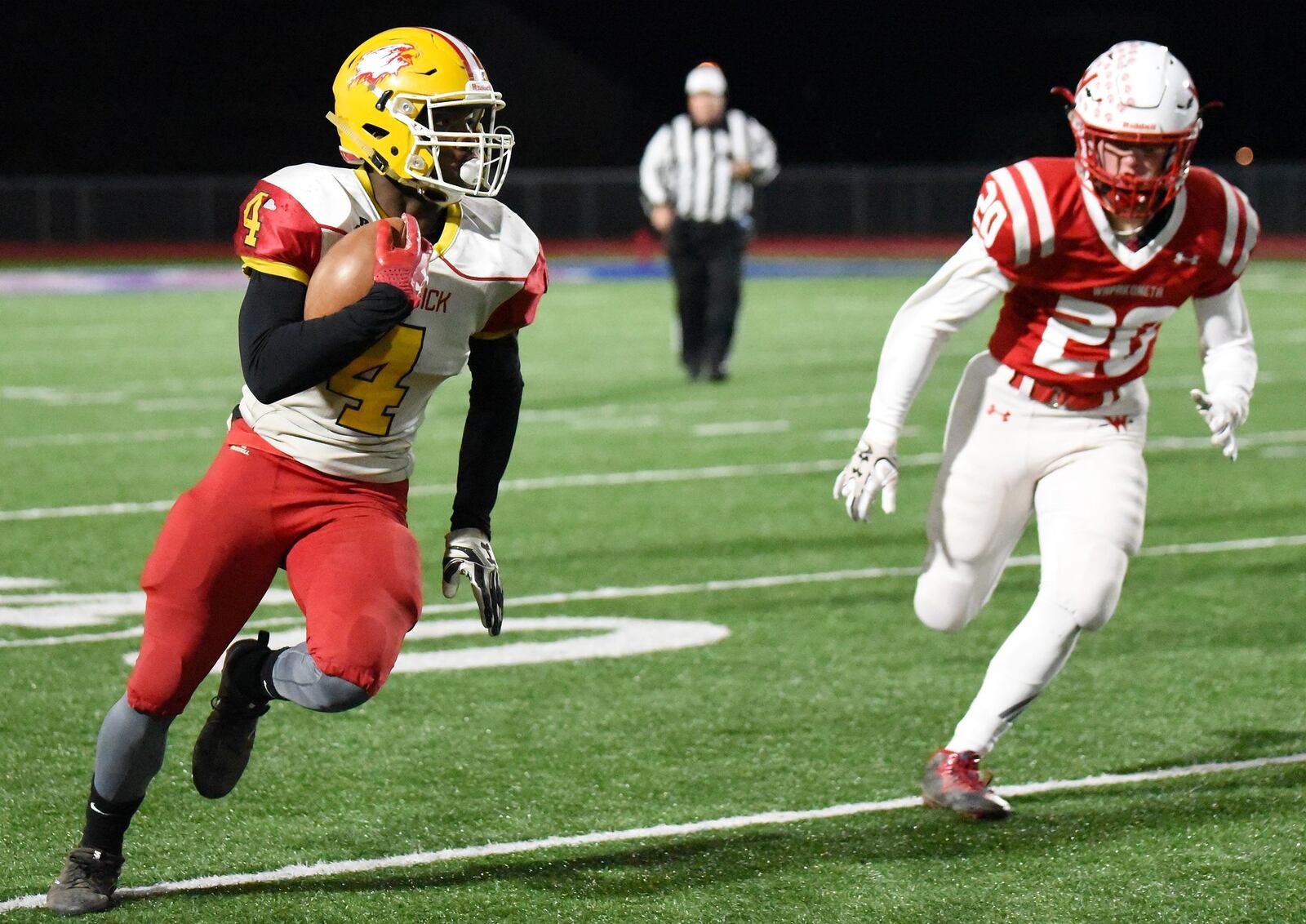 Fenwick’s Caleb Davis (4) runs past Wapakoneta’s Garrett Siefring (20) during Friday night’s Division III, Region 12 playoff semifinal at Piqua’s Purk Field at Alexander Stadium. CONTRIBUTED PHOTO BY ANGIE MOHRHAUS