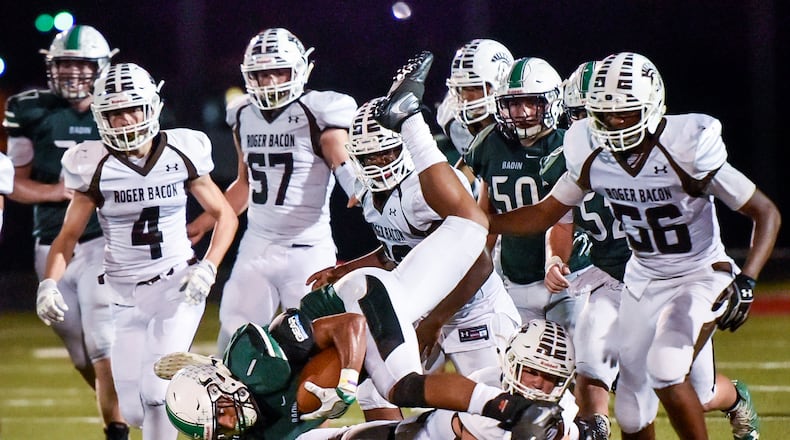 Badin’s Davon Starks gets inverted as he carries the ball during a game against Roger Bacon on Sept. 22, 2017, at Fairfield Stadium in Fairfield. NICK GRAHAM/STAFF
