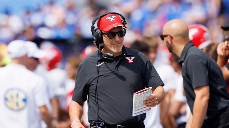 Youngstown State head coach Doug Phillips looks at his play sheet during the first half of an NCAA college football game against Kentucky in Lexington, Ky., Saturday, Sept. 17, 2022. (AP Photo/Michael Clubb)