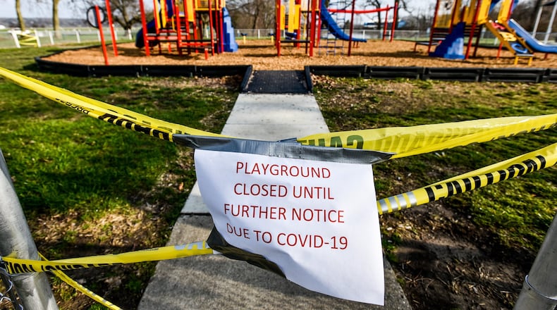 The playgrounds at Smith Park in Middletown has caution tape and signs indicating it is closed due to COVID-19. Many playgrounds in Butler County are off limits as a precaution against the spread of coronavirus. NICK GRAHAM / STAFF