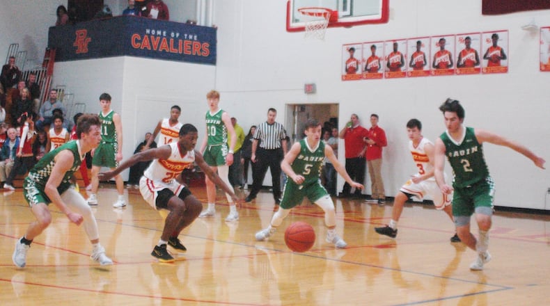 Badin’s Joseph Walsh (left), Donovan Watkins (5) and Seth Hargis (2), along with Purcell Marian’s Dustin Davis (25) and Zach Hoover (13), eye a loose ball during Friday night’s game at the Eveslage Athletic Center. Host Purcell won 74-60. RICK CASSANO/STAFF