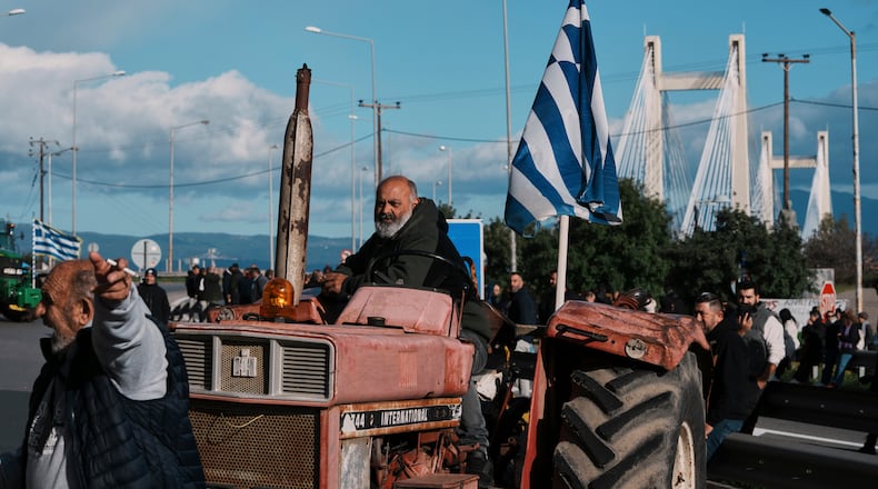 Farmers block the Chalkida Bridge with tractors during a protest over delays in European Union–backed agricultural subsidy payments, on Evia island, Greece, Thursday, Jan. 8, 2026. (AP Photo/Thanassis Stavrakis)