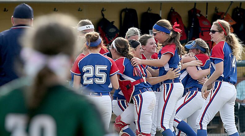 Springfield Northwestern celebrates its win as Badin’s Hannah Broermann comes out to shake hands with the Warriors after their Division III regional softball semifinal at Wright State University on Thursday. CONTRIBUTED PHOTO BY E.L. HUBBARD
