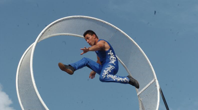 Ricardo Flores of the Fearless Flores Circus and Thrill Show, runs to keep up with the spinning ring. The thrill show, which boasts a high-wire act, a globe of death, and an aerial swaypole where daredevils perch 60 feet up in the air, is one of the new attractions at the Warren County Fair this year. CONTRIBUTED
