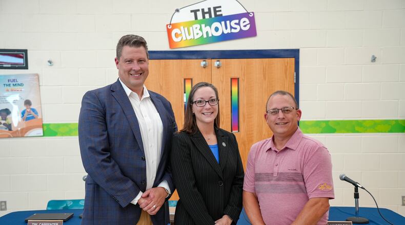 The Monroe Schools governing board unanimously voted Monday evening to hire Hamilton County’s Sycamore Schools Assistant Treasurer Amy Moore, center, as its new treasurer. Pictured at Monday’s board meeting (left to right) are Monroe Superintendent Robert Buskirk, Moore and Monroe School Board President Dave Grant. CONTRIBUTED