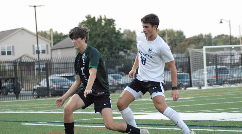Badin senior Brayden Eldridge (17) and McNicholas junior Roland Gabriel (18) fight for position during their game on Tuesday at Spooky Nook. Chris Vogt/CONTRIBUTED
