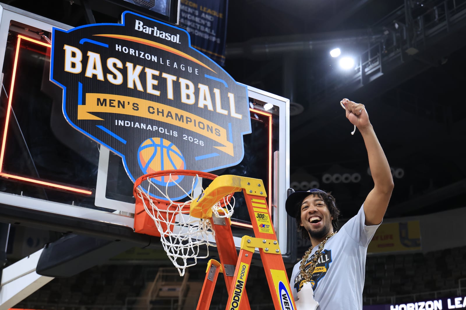 Wright State University's Logan Woods holds up piece of the net after beating Detroit Mercy 66-63 to win the Horizon League tournament championship on Tuesday, March 10, 2026 at the Corteva Coliseum in Indianapolis. HORIZON LEAGUE / CONTRIBUTED PHOTO