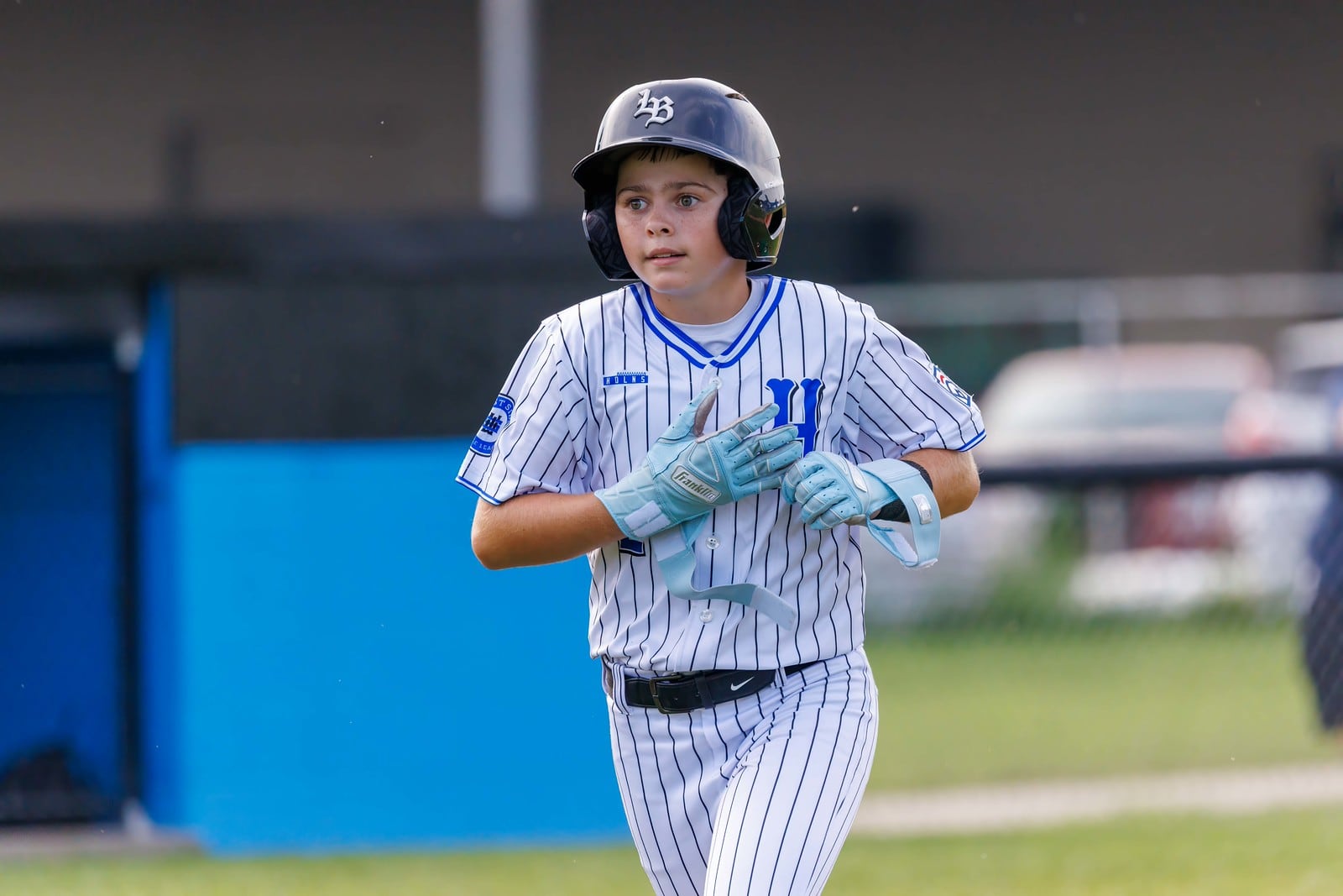 West Side's Jordan Malloy hustles off the field during his Ohio Little League District 9 tournament game against Loveland on Tuesday at West Side Little League. West Side won 14-0. TOM PATE / CONTRIBUTED