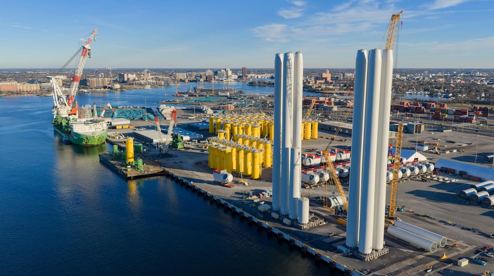 Wind turbine bases, generators and blades are positioned at The Portsmouth Marine terminal that is the staging area for Dominion Energy's wind turbine project Monday Dec. 22, 2025, in Portsmouth, Va. (AP Photo/Steve Helber)