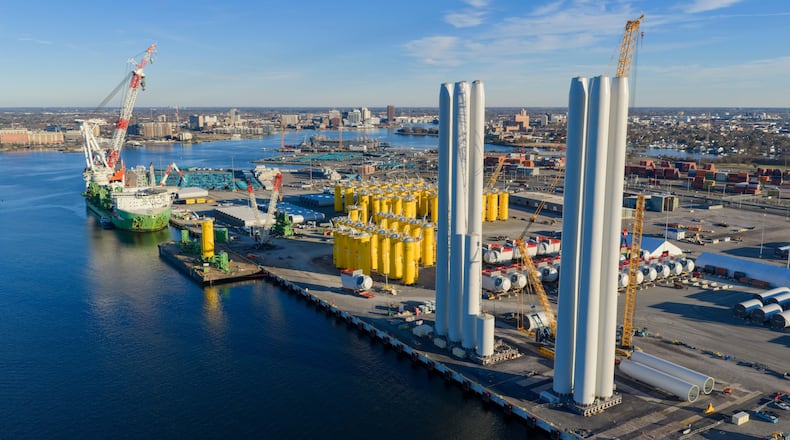 Wind turbine bases, generators and blades are positioned at The Portsmouth Marine terminal that is the staging area for Dominion Energy's wind turbine project Monday Dec. 22, 2025, in Portsmouth, Va. (AP Photo/Steve Helber)