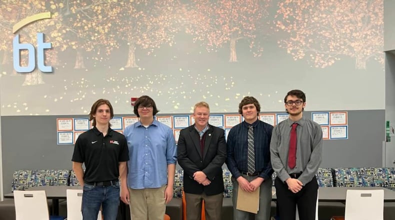 Four Butler County high school seniors recently won first place in the region's Congressional App Challenge for the 8th Congressional district. Their app helps users find silicon recycling centers in the area to help combat the nationwide shortage of the vital metal used to create computer semi-conductors. Pictured L-R are Robert Guise, Jacob Reed, U.S. Congressman Warren Davidson, Ethan Flohr and Micah Bolton during an awards presentation. (Provided Photo\Journal-News)