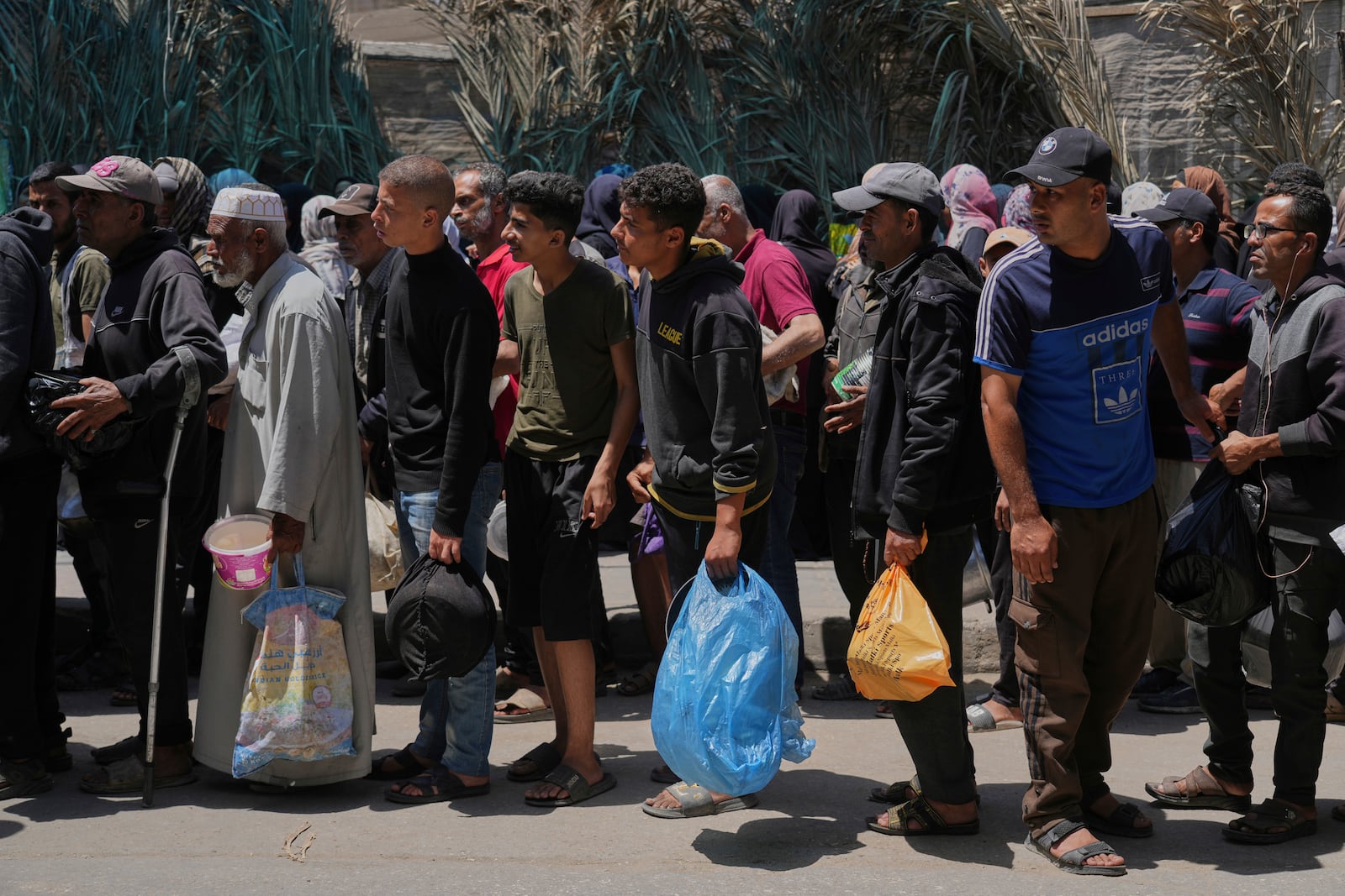 Palestinians line up for food distribution in Deir al-Balah, Gaza Strip, Friday, May 30, 2025. (AP Photo/Abdel Kareem Hana)