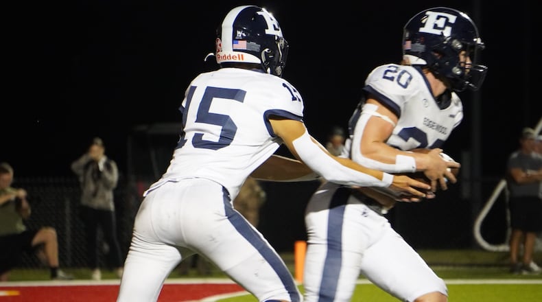 Edgewood quarterback Ryan Weber hands the ball off to Miller Fall during their game against Fenwick on Thursday night at Yeager Field. CHRIS VOGT / CONTRIBUTED