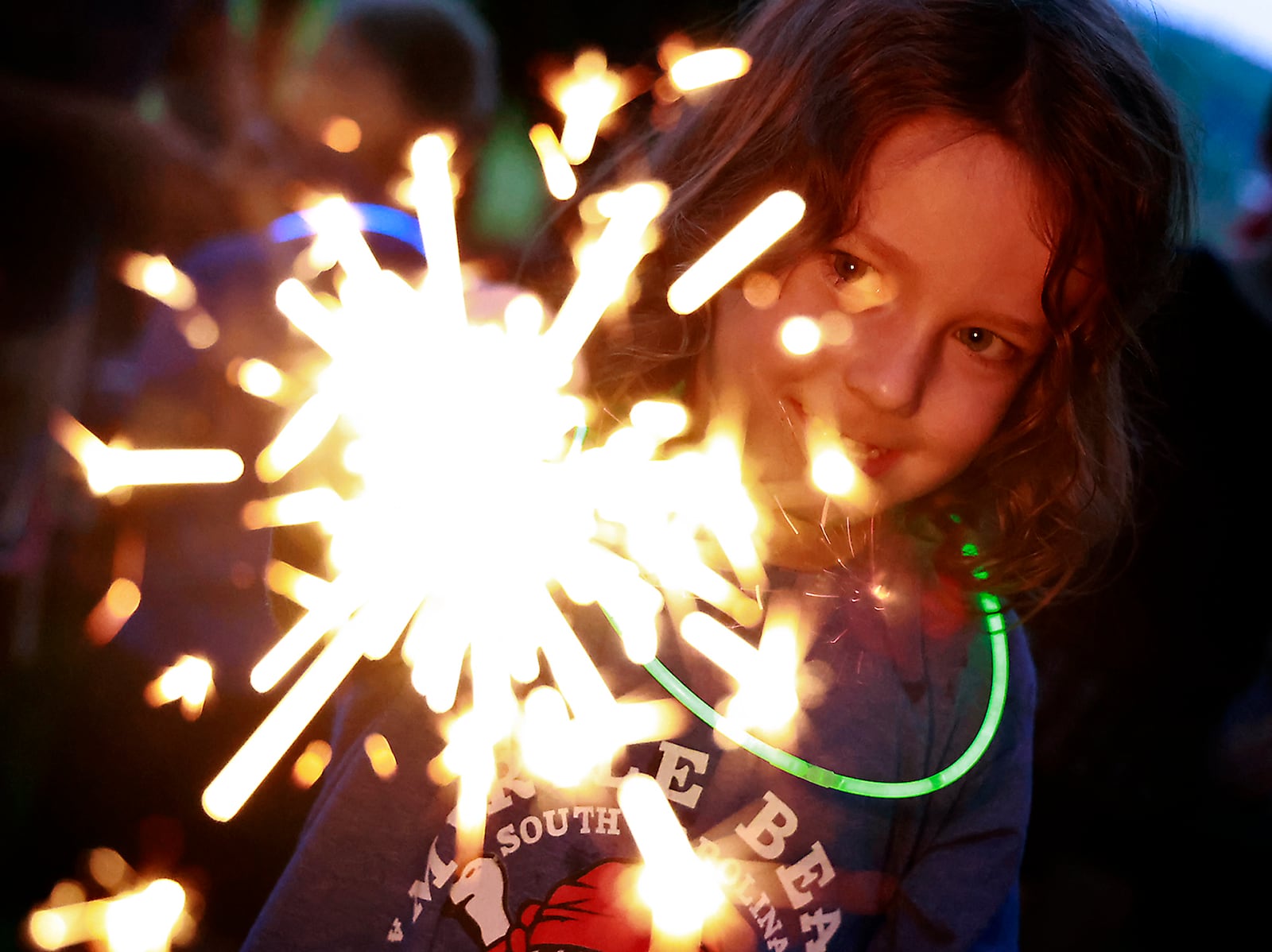 Rowan Irick, 4, plays with a sparkler Monday, July 3, 2023 at Ferncliff Cemetery before the Buck Creek Boom fireworks show. BILL LACKEY/STAFF