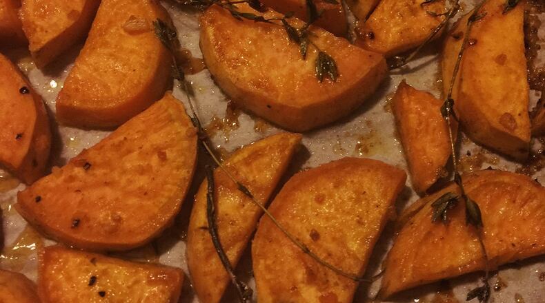These Garlic ‘N’ Honey Roasted Sweets are a modern twist on traditional candied sweet potatoes. The garlic along with chipotle chile powder provide a delectable balance to the sweetness of the honey and potatoes. CONNIE POST/STAFF