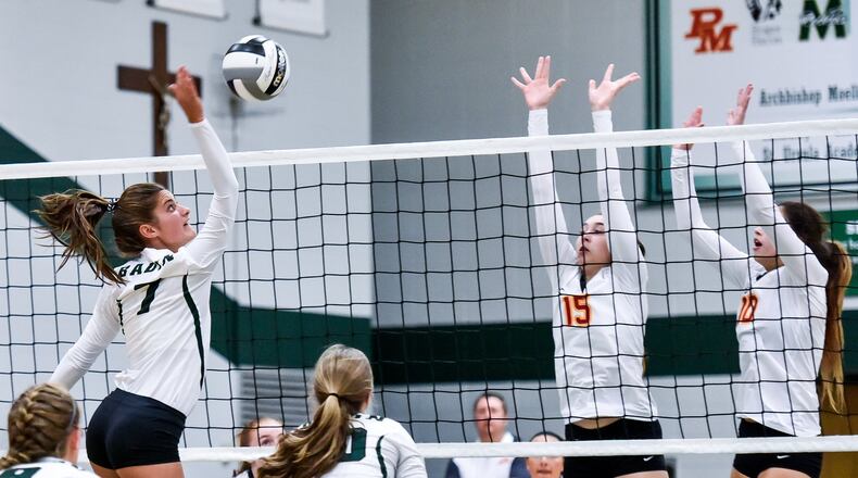 Fenwick’s Julia Gardon (15) and Riley Wildfeuer (10) block a shot by Badin’s Pamela Larkin during their volleyball match Thursday night at Mulcahey Gym in Hamilton. NICK GRAHAM/STAFF