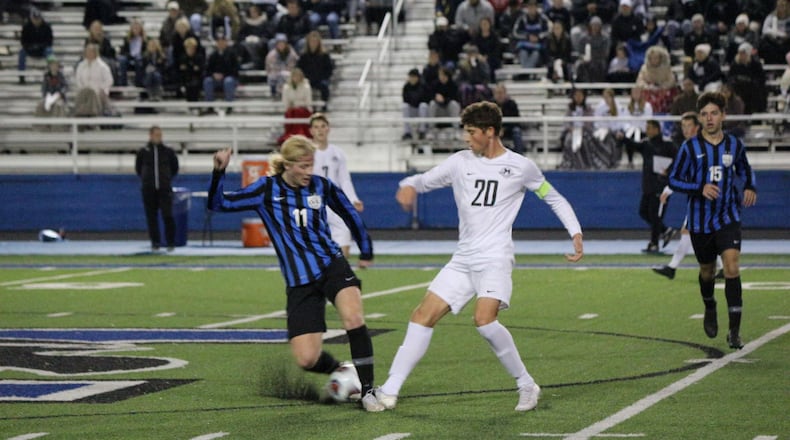 Lakota East’s Ethan Seppi (20) battles Olentangy Liberty’s Jaggar Brooker for possession during a Division I state semifinal match on Wednesday, Nov. 6. Greg Billing/CONTRIBUTED