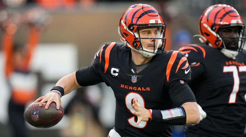 Cincinnati Bengals quarterback Joe Burrow (9) throws during the first half of an NFL wild-card playoff football game against the Las Vegas Raiders, Saturday, Jan. 15, 2022, in Cincinnati. (AP Photo/AJ Mast)