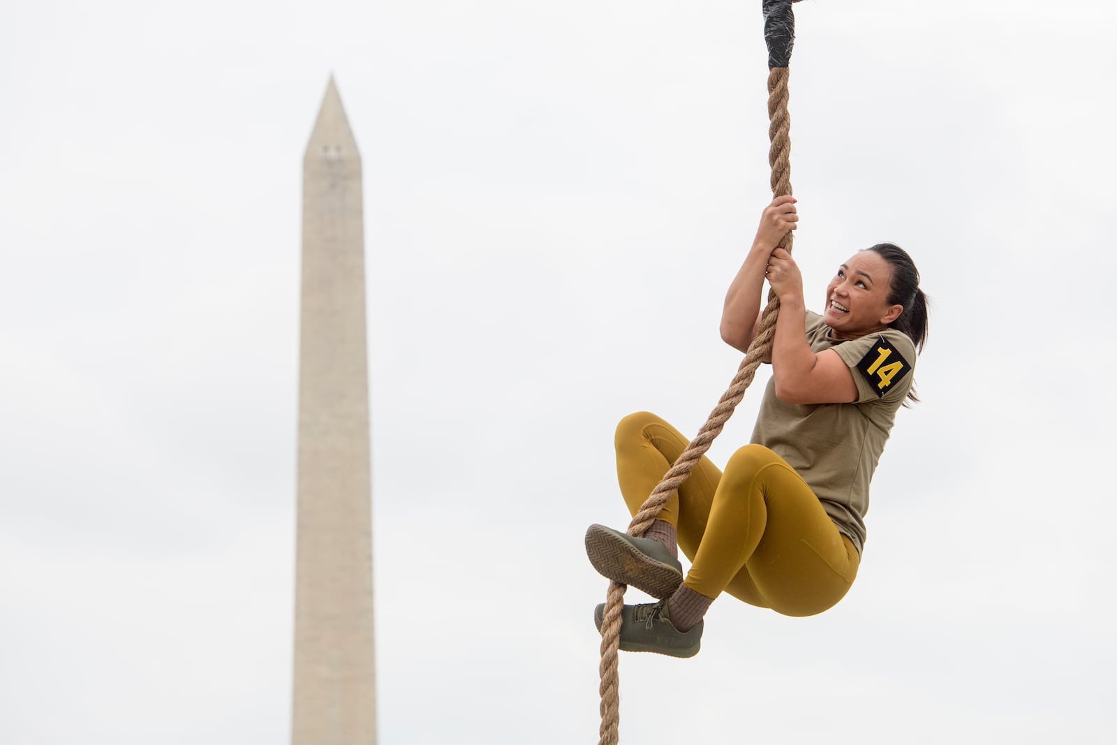 A team member competes in the rope climb portion of the Army fitness competition during the festival event to honor the Army's 250th anniversary and coinciding with President Donald Trump's 79th birthday, Saturday, June 14, 2025, on the National Mall in Washington. (AP Photo/Rod Lamkey, Jr.)